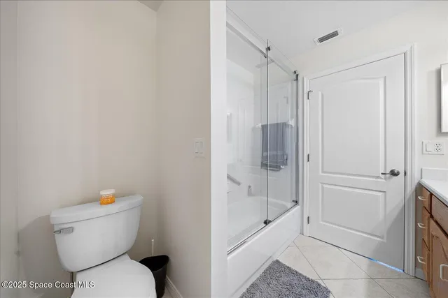 a white toilet sitting next to a bathroom