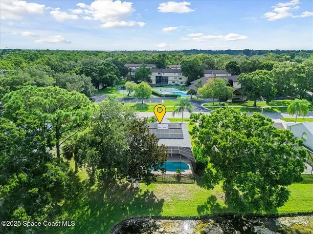 a view of a house with a swimming pool a yard and outdoor seating