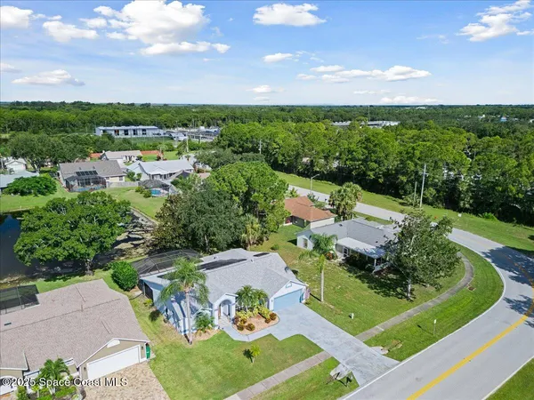 an aerial view of a house with garden space and street view