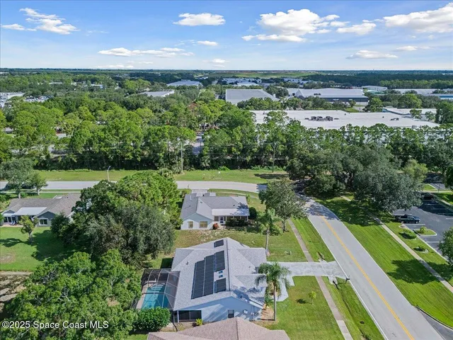 an aerial view of a house with a big yard