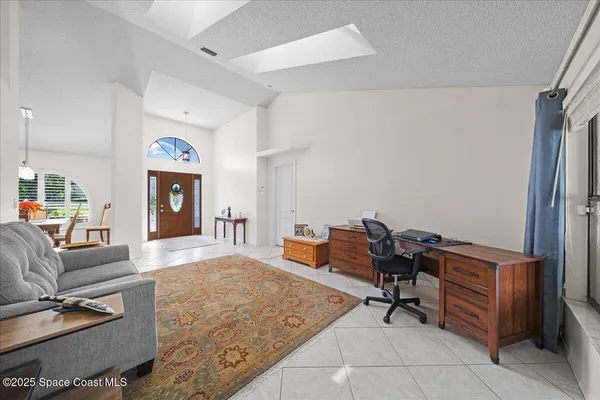 a living room with furniture and a piano