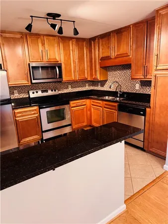 a kitchen with stainless steel appliances a sink and a microwave