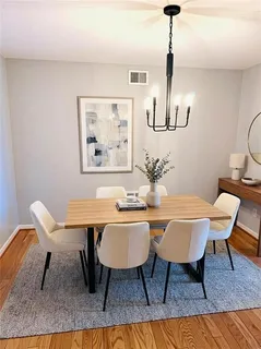 a dining room with furniture a rug and wooden floor