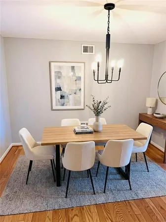 a dining room with furniture a rug and wooden floor