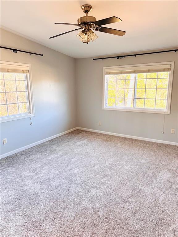 1468 Briarwood Road Northeast, Unit 1008 Atlanta, GA 30319 - Photo 18 of 44 an empty room with windows and ceiling fan