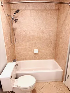 a bathroom with a toilet bathtub and shower