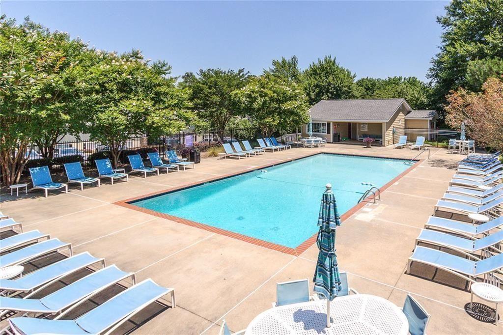 1468 Briarwood Road Northeast, Unit 1008 Atlanta, GA 30319 - Photo 32 of 44 a view of a swimming pool with an outdoor seating