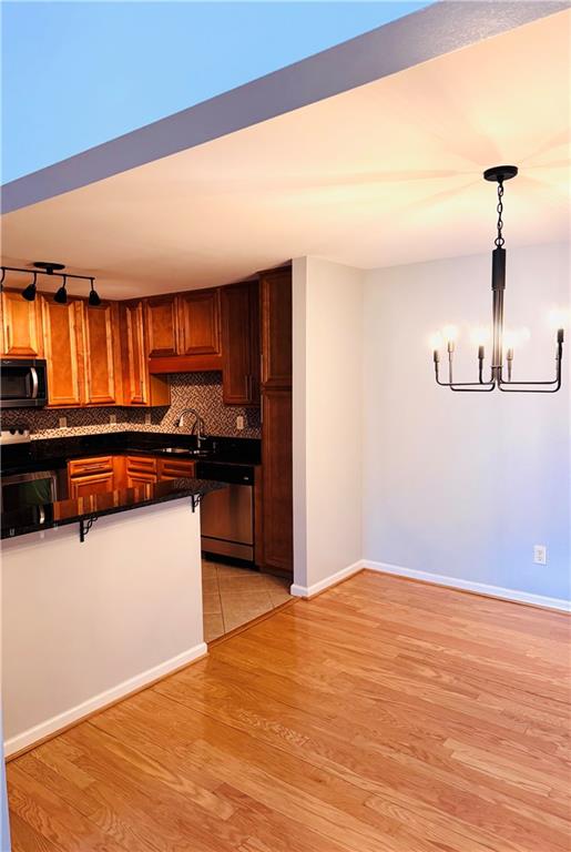 1468 Briarwood Road Northeast, Unit 1008 Atlanta, GA 30319 - Photo 42 of 44 a kitchen with stainless steel appliances granite countertop a refrigerator and a stove top oven
