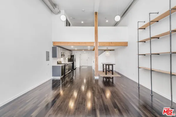 a view of a room with wooden floor