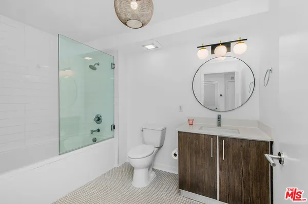 a bathroom with a toilet a sink and a mirror