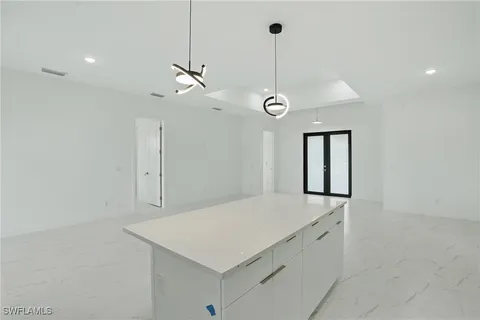 an empty room with a ceiling fan and a shower