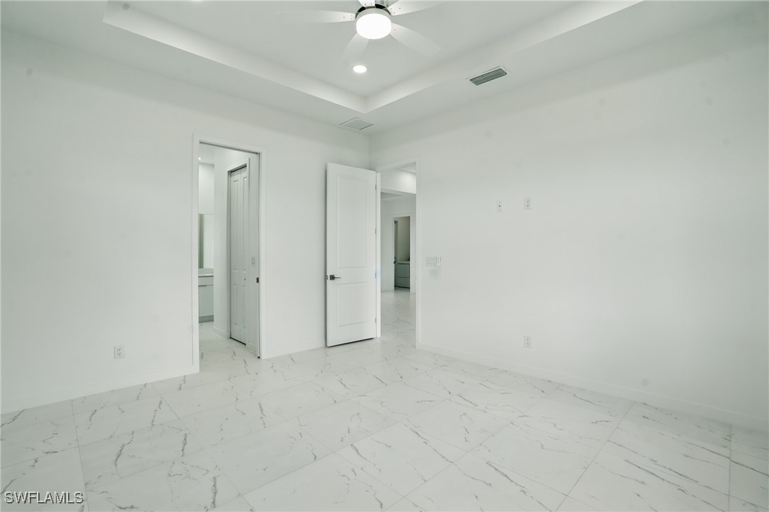 472 Rajah Street Lehigh Acres, FL 33974 - Photo 14 of 29 an empty room with a ceiling fan and a shower