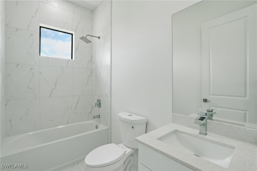 472 Rajah Street Lehigh Acres, FL 33974 - Photo 21 of 29 a bathroom with a sink toilet and shower