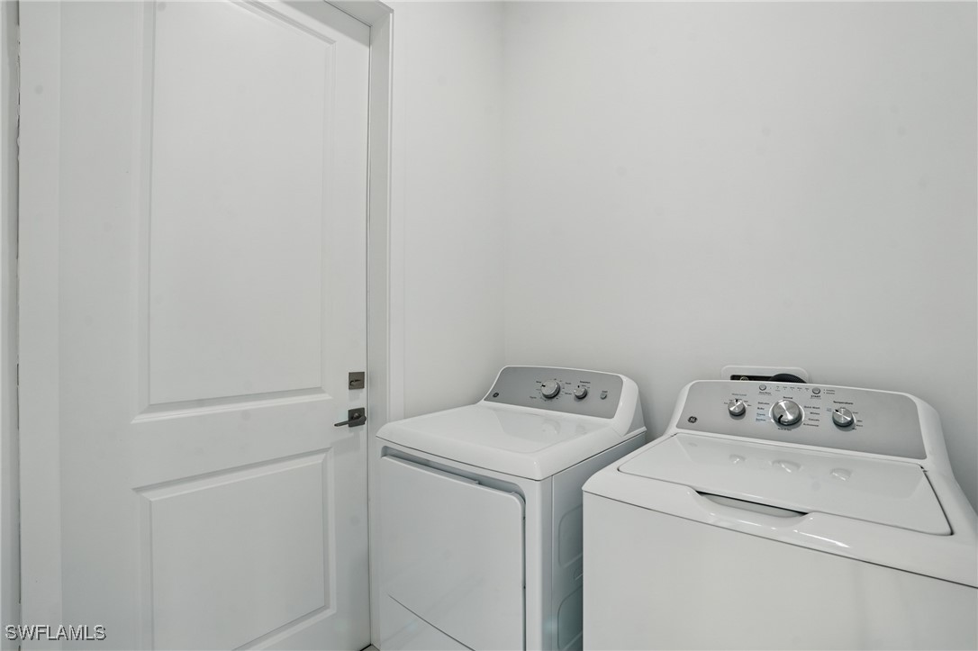 472 Rajah Street Lehigh Acres, FL 33974 - Photo 24 of 29 a utility room with dryer and washer