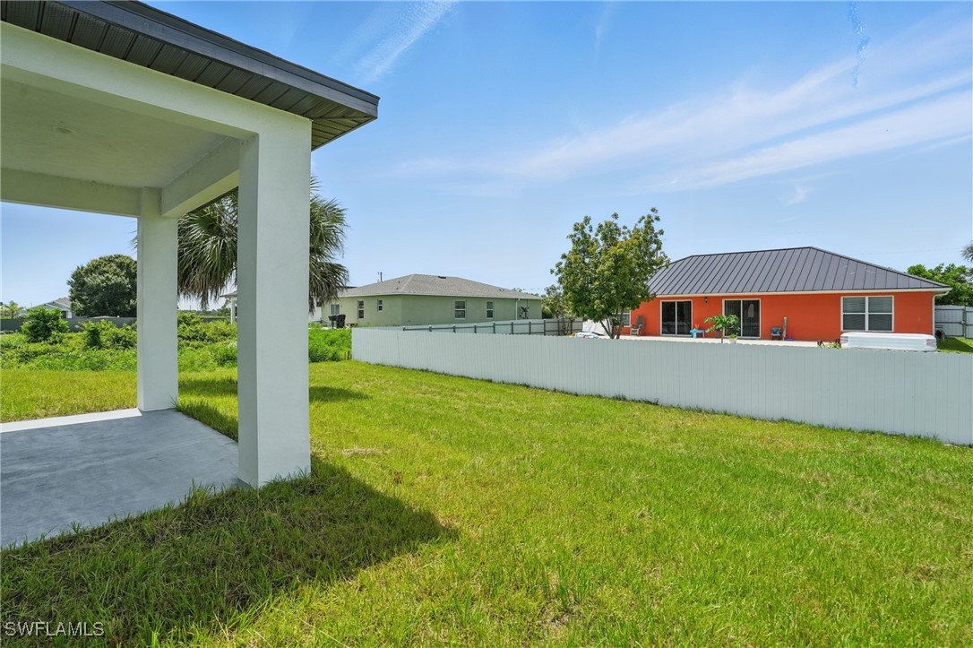 472 Rajah Street Lehigh Acres, FL 33974 - Photo 26 of 29 a front view of house with yard and outdoor seating