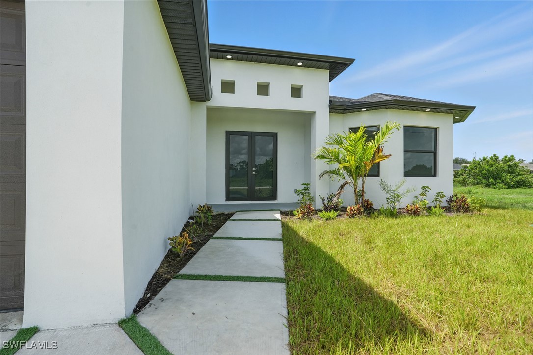 472 Rajah Street Lehigh Acres, FL 33974 - Photo 3 of 29 a front view of a house with garden