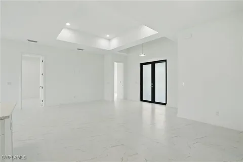 a view of kitchen with kitchen island white cabinets and stainless steel appliances