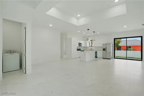 a view of a kitchen with a sink and a large window