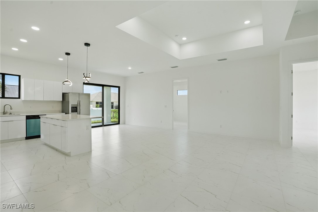 472 Rajah Street Lehigh Acres, FL 33974 - Photo 7 of 29 a view of kitchen with kitchen island white cabinets and stainless steel appliances