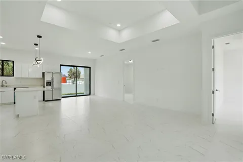 a kitchen with a refrigerator a stove and a sink