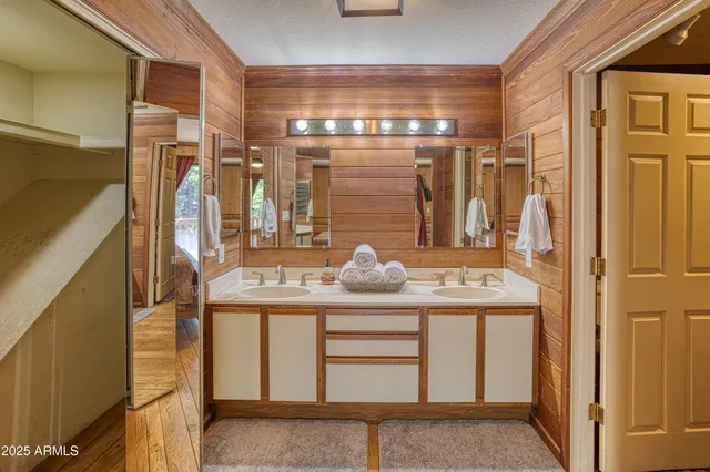 a bathroom with a sink a mirror and shower