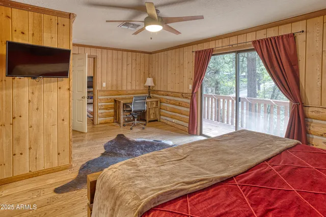a bedroom with a bed and a flat tv screen
