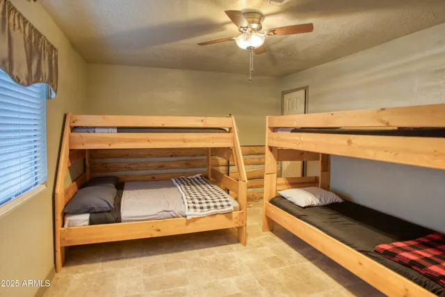 a bedroom with bunk bed and a chandelier