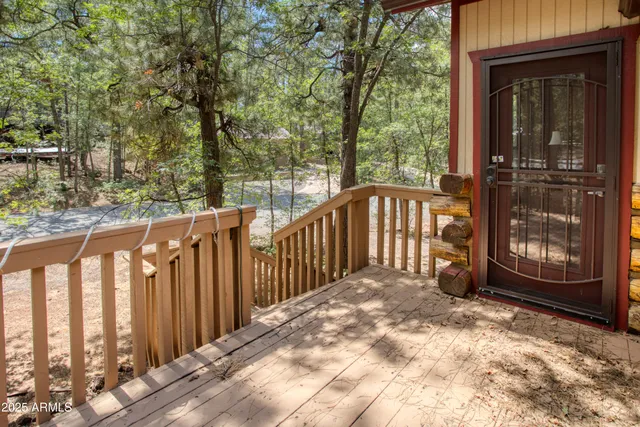 a view of a wooden fence with a small yard