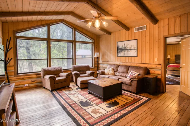 a living room with furniture a rug and a large window