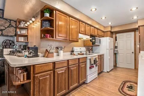 a kitchen with a sink refrigerator and cabinets