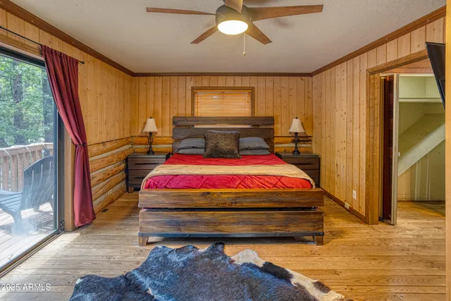 a bed sitting in a spacious bedroom next to a window