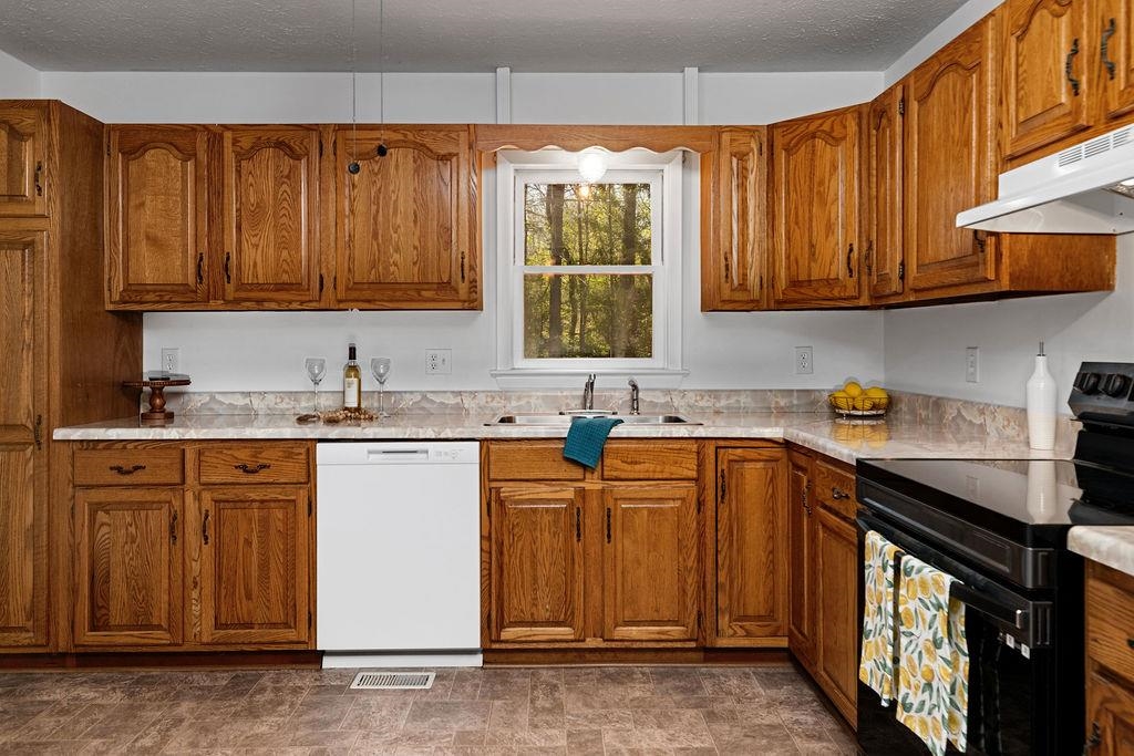 2051 Mt Torrey Road Lyndhurst, VA 22952 - Photo 31 of 67 a kitchen with stainless steel appliances granite countertop a sink stove and cabinets