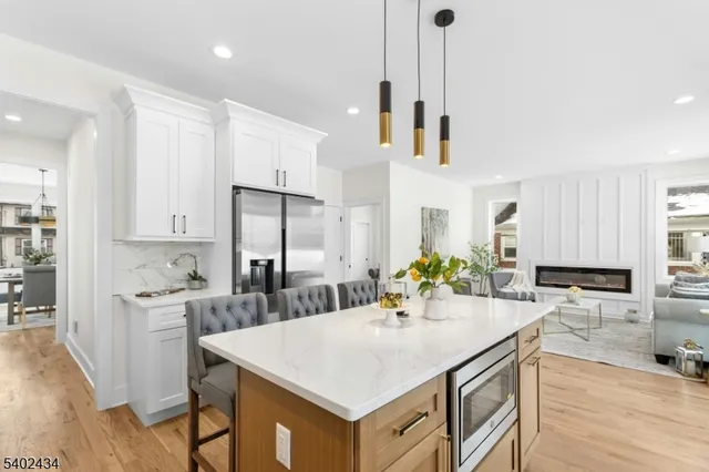 a kitchen with a sink a counter top space stainless steel appliances and cabinets