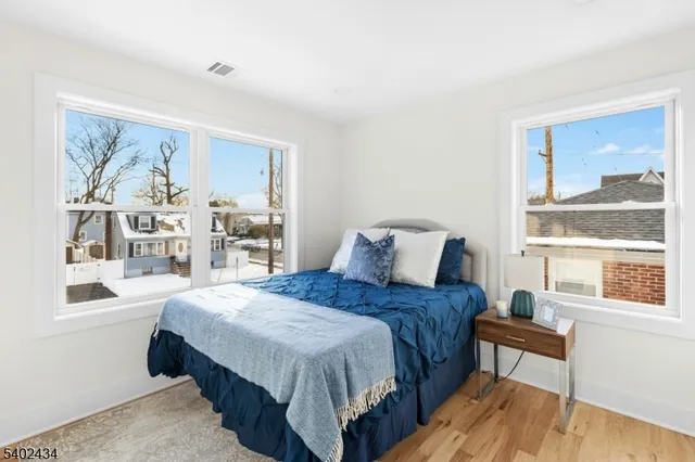 a bedroom with a large bed and a window