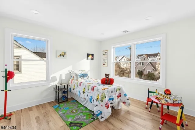 a bedroom with baby bed and a window