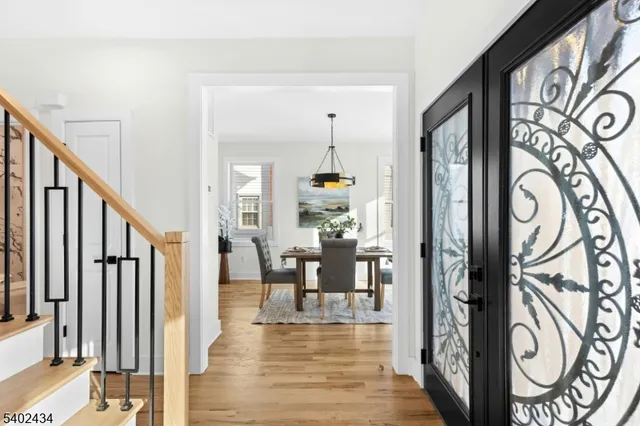 a view of a hallway with wooden floor and couches