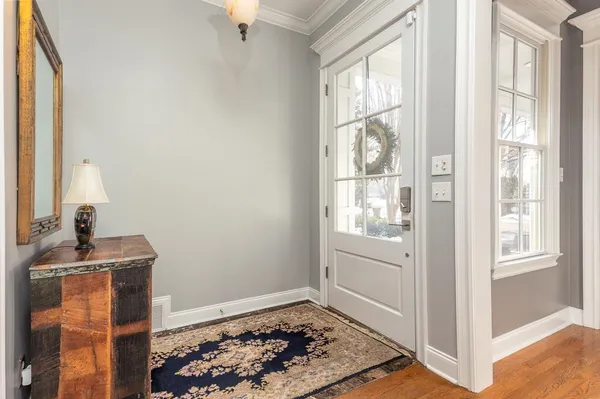 a living room with fireplace furniture and a rug
