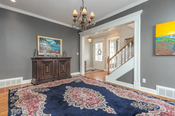 a living room with furniture fireplace and a large window