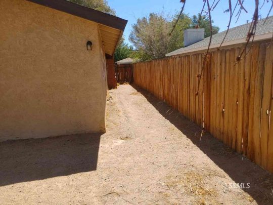 421 South Valley Street Ridgecrest, CA 93555 - Photo 18 of 20 a view of a backyard with wooden fence