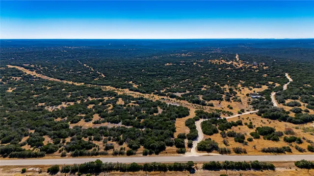 an aerial view of residential houses with city view