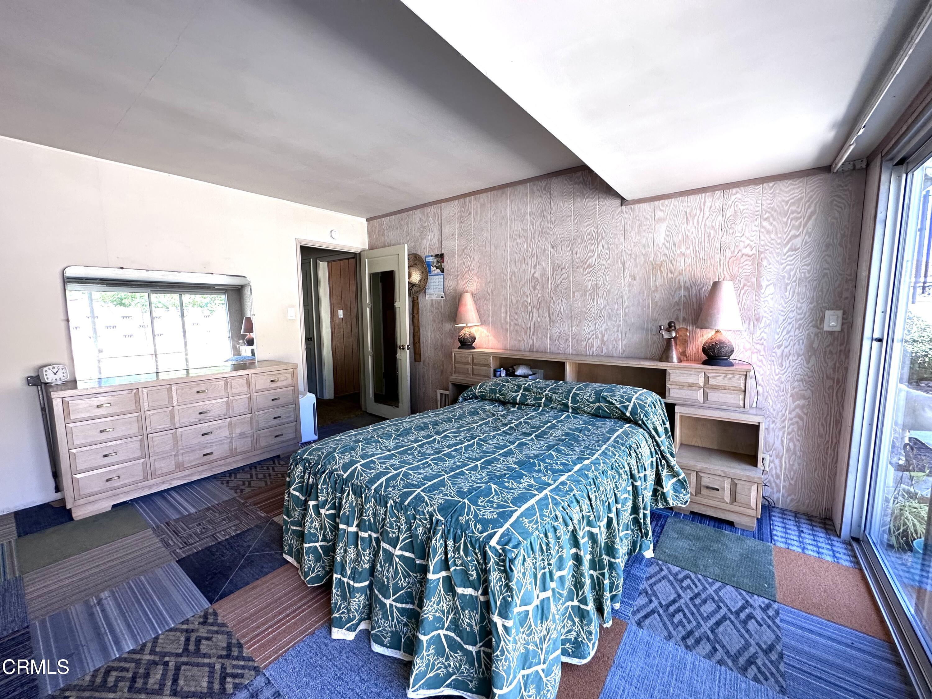 3895 Mayfair Drive Pasadena, CA 91107 - Photo 13 of 18 a bed sitting in a bedroom next to a window with wooden floor