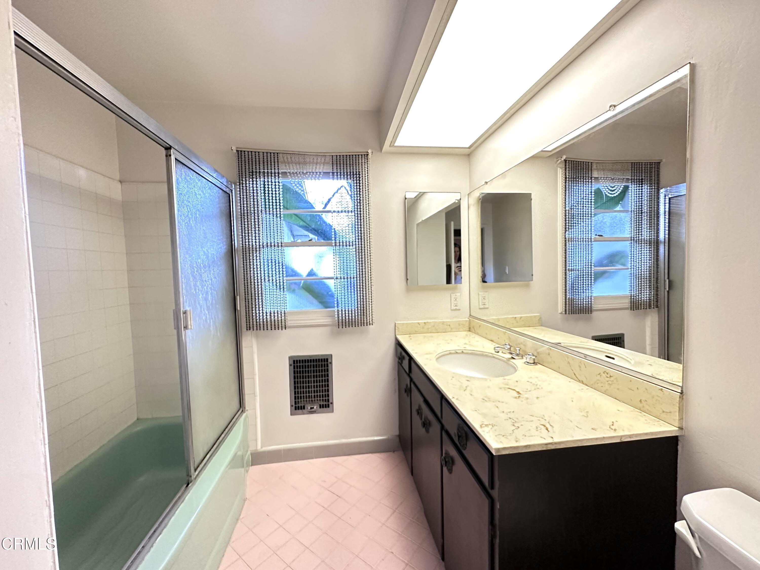 3895 Mayfair Drive Pasadena, CA 91107 - Photo 14 of 18 a bathroom with a granite countertop sink and a mirror