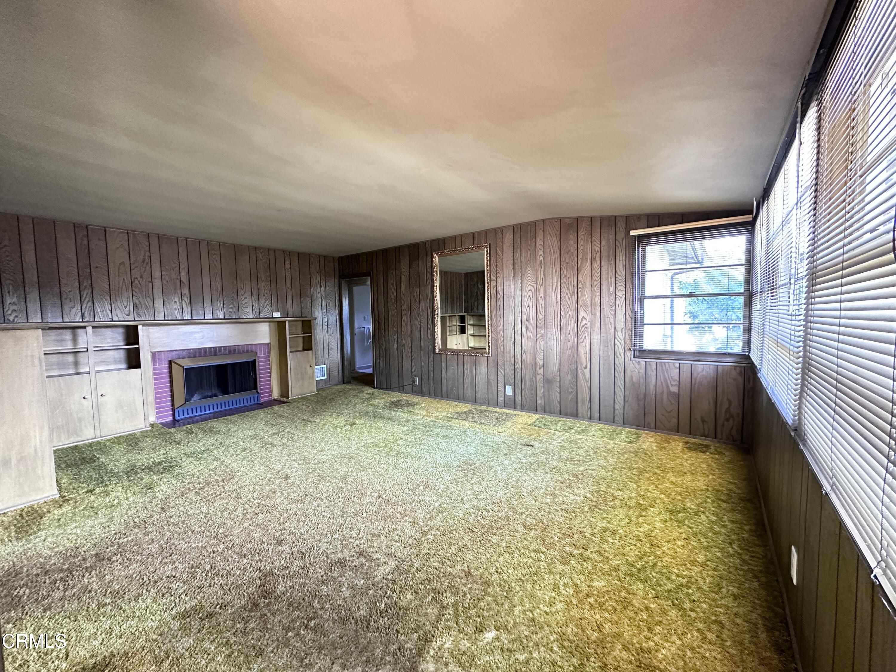 3895 Mayfair Drive Pasadena, CA 91107 - Photo 3 of 18 an empty room with fireplace and windows