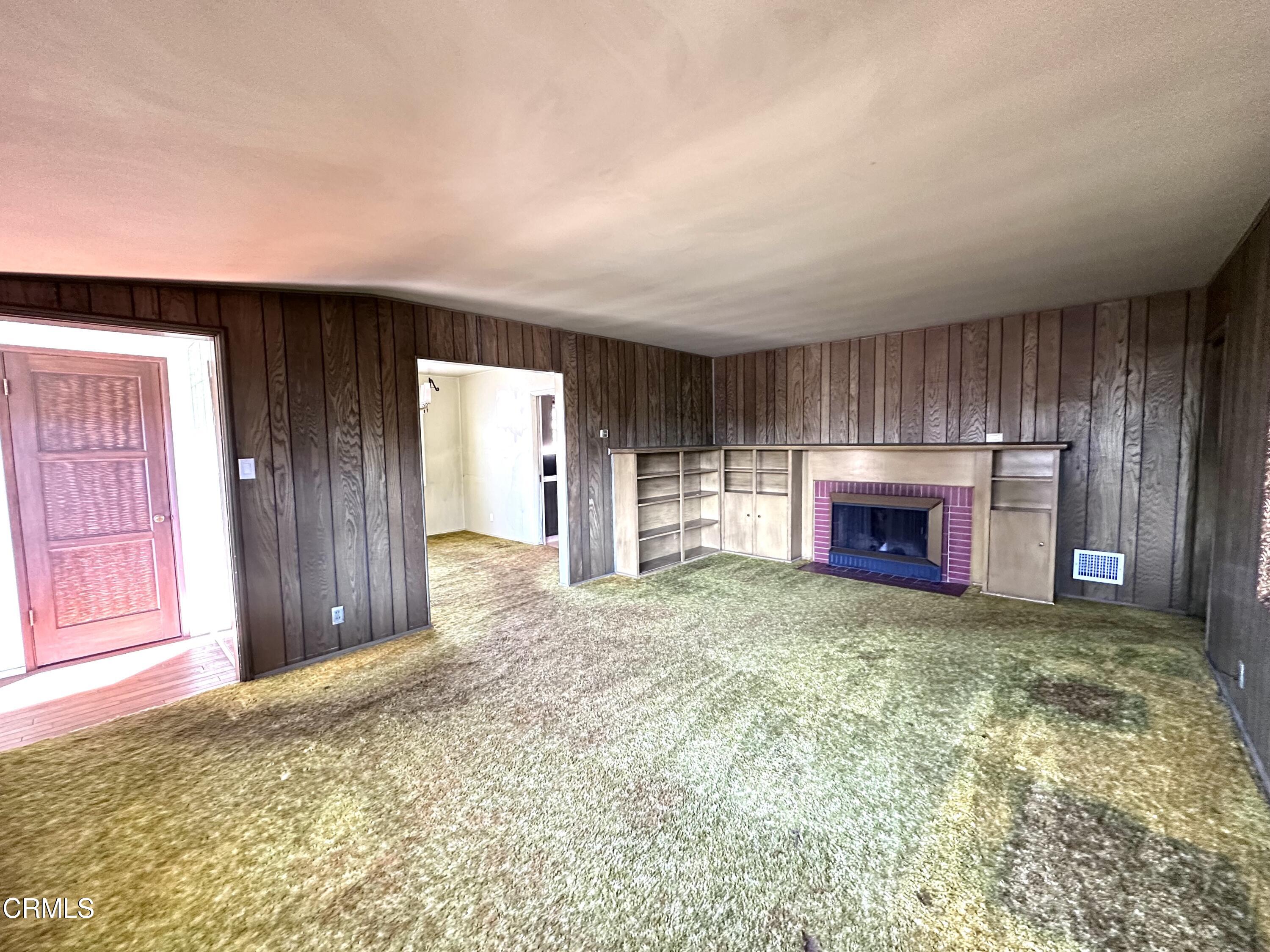 3895 Mayfair Drive Pasadena, CA 91107 - Photo 4 of 18 an empty room with fireplace and windows