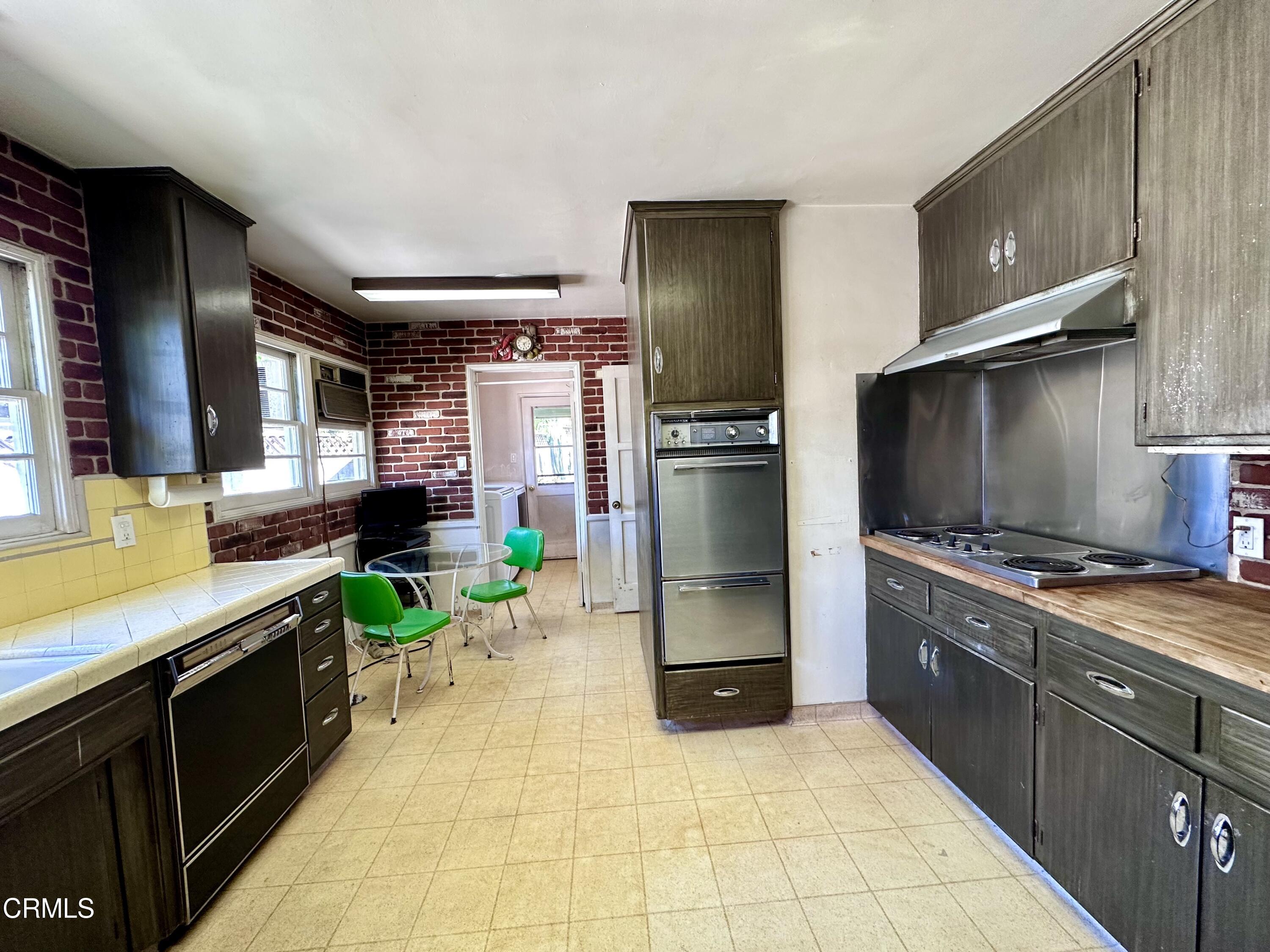 3895 Mayfair Drive Pasadena, CA 91107 - Photo 5 of 18 a kitchen with stainless steel appliances granite countertop a sink and a refrigerator