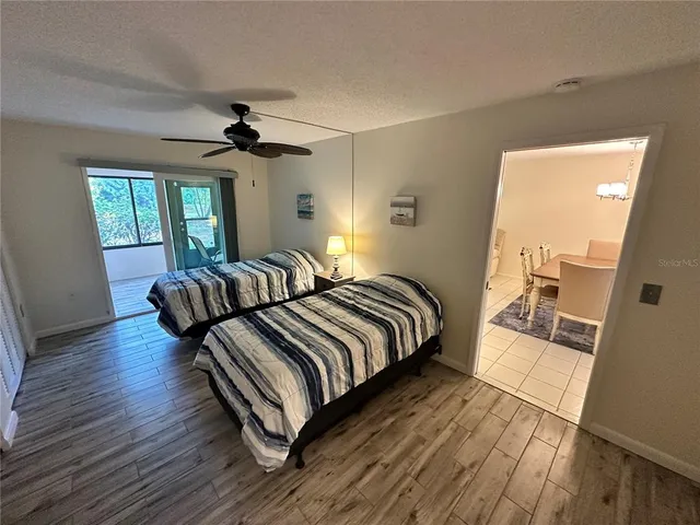 a spacious bedroom with a bed and a chandelier