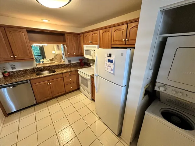 a kitchen with a refrigerator sink stove and cabinets