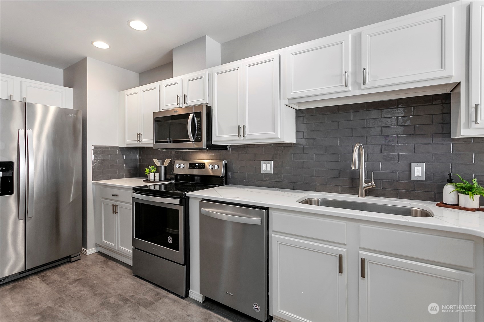 1011 Bancroft Street, Unit 303 Bellingham, WA 98225 - Photo 12 of 40 a kitchen with stainless steel appliances granite countertop a refrigerator sink and microwave