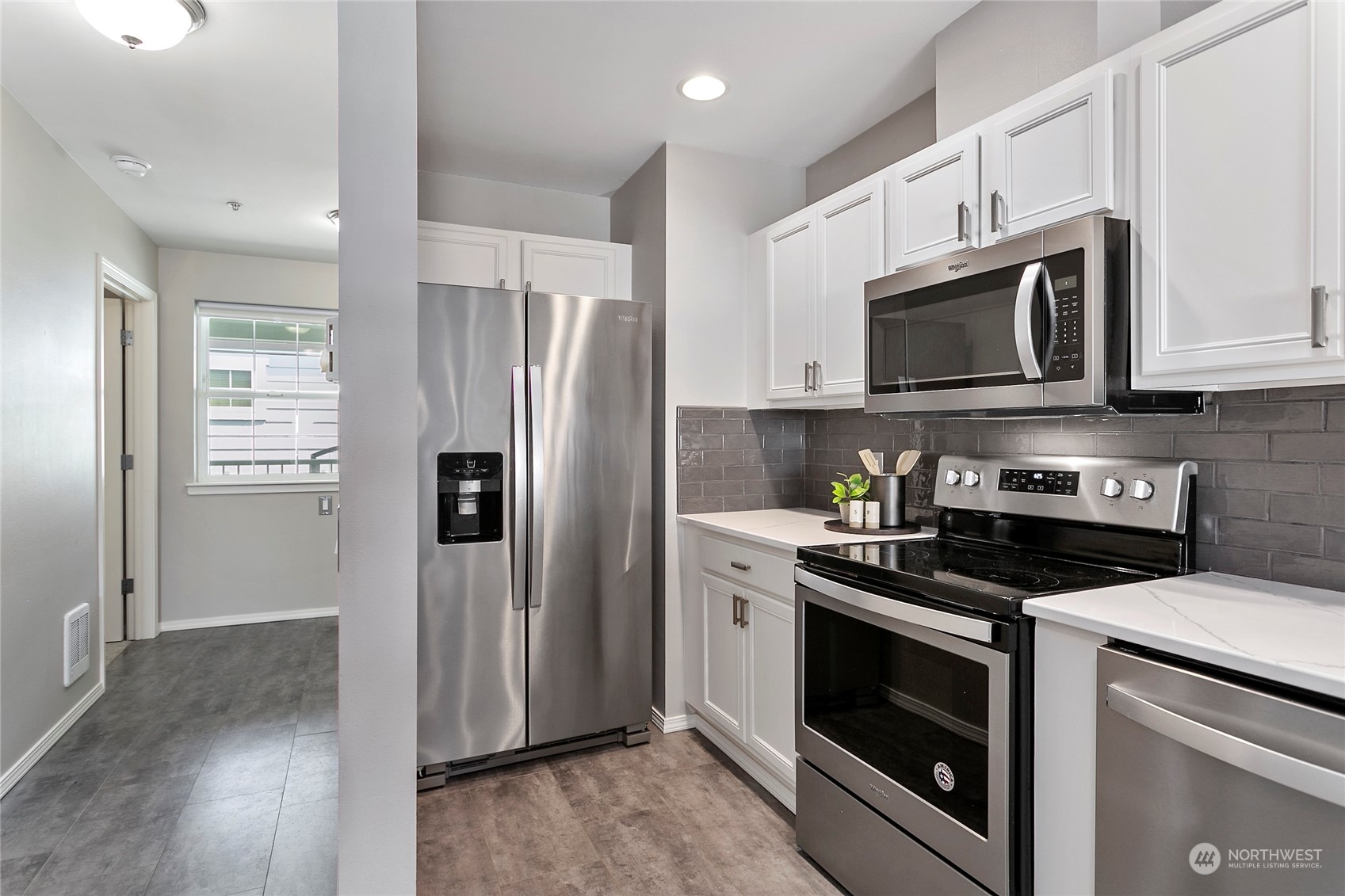 1011 Bancroft Street, Unit 303 Bellingham, WA 98225 - Photo 13 of 40 a kitchen with stainless steel appliances granite countertop a stove a refrigerator and a microwave