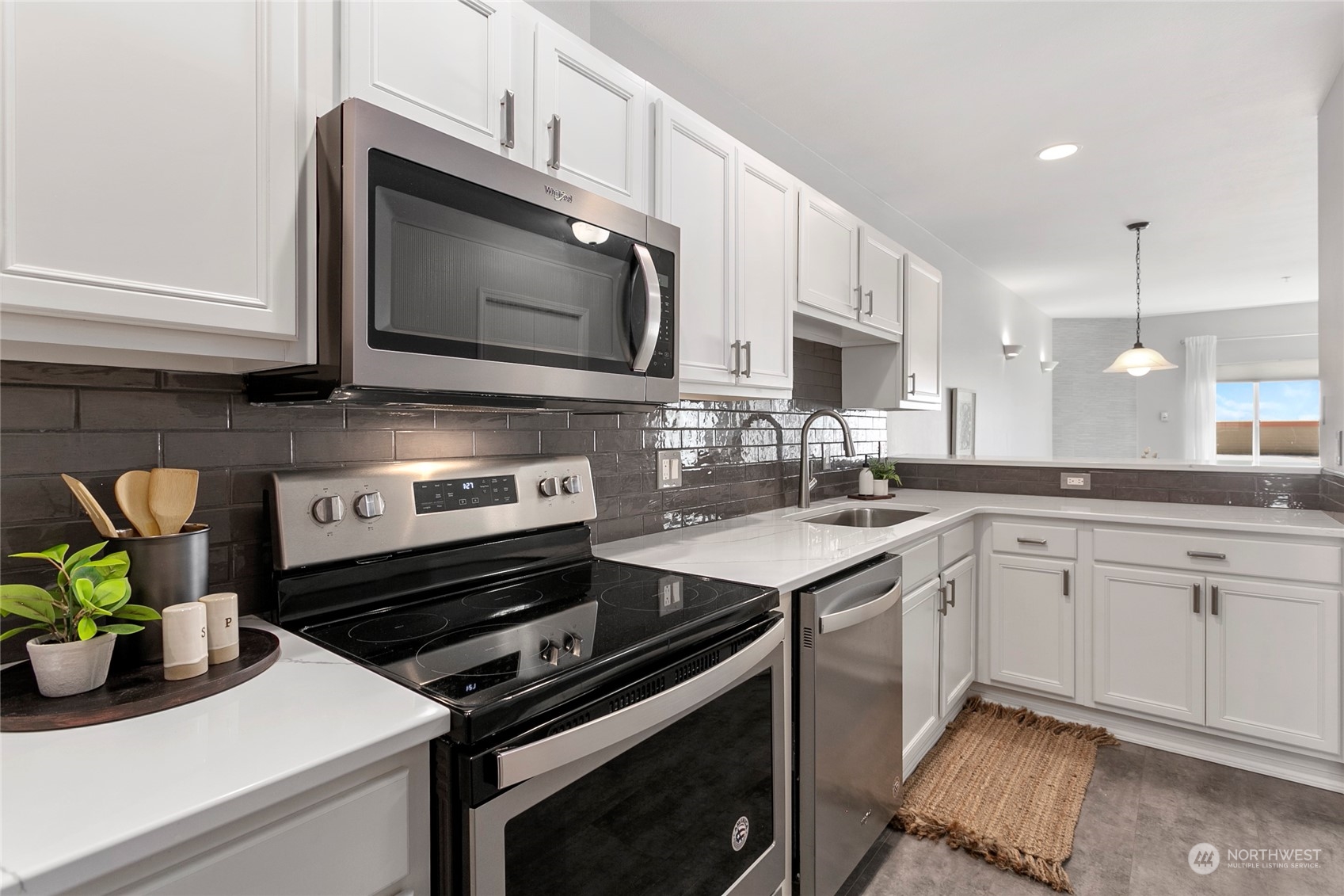1011 Bancroft Street, Unit 303 Bellingham, WA 98225 - Photo 16 of 40 a kitchen with a stove microwave and sink